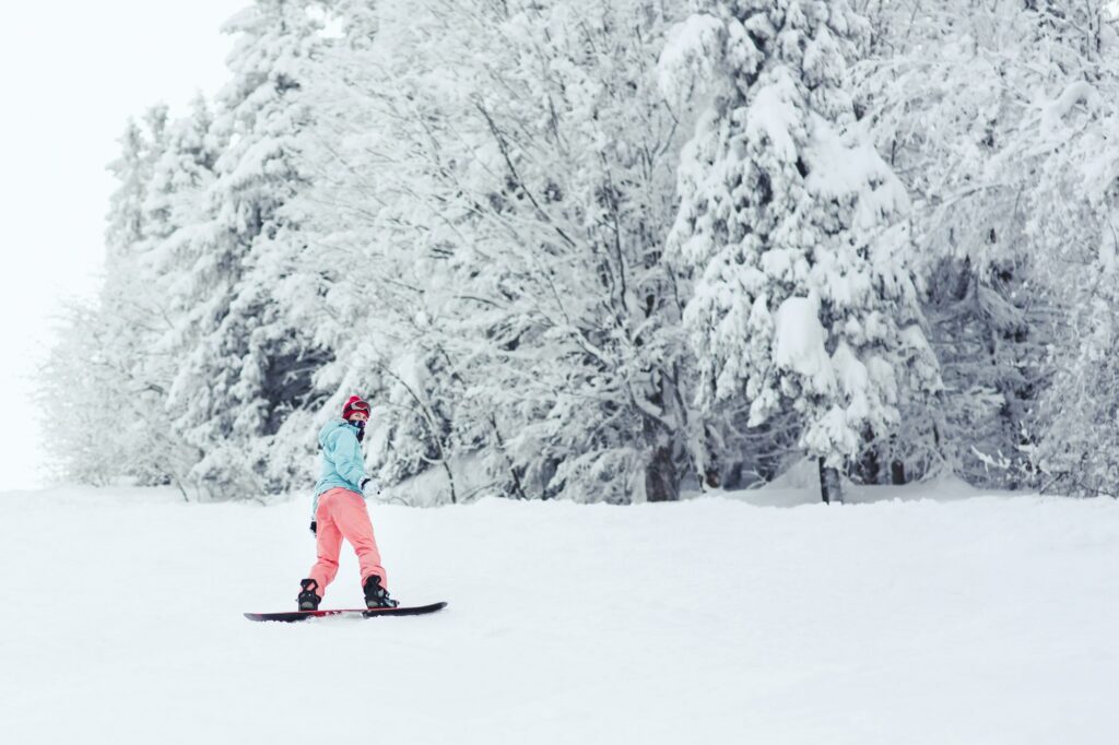 Snowboarder nel bosco innevato